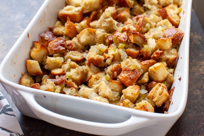close up of stuffing recipe in a white baking dish