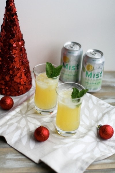 Fresh fruit juices in glass bottles on ice. by John Greene. Photo