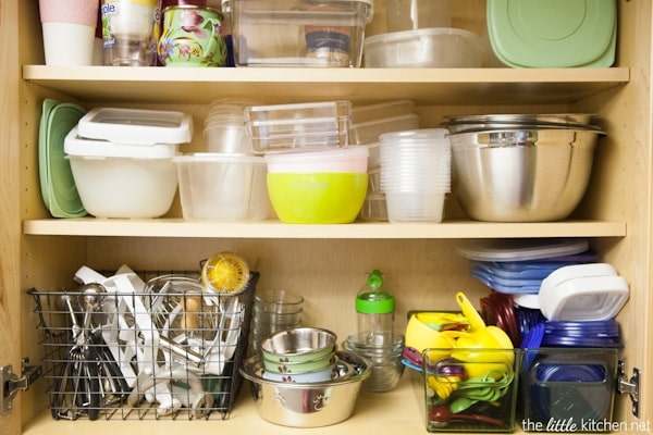 Kitchen Organizing Tip: In your cabinets, use baskets and bins to organize food storage containers & lids as well measuring cups and spoons.