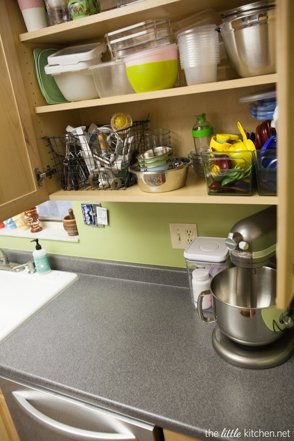 Kitchen Organizing Tip: In your cabinets, use baskets and bins to organize food storage containers & lids as well measuring cups and spoons.