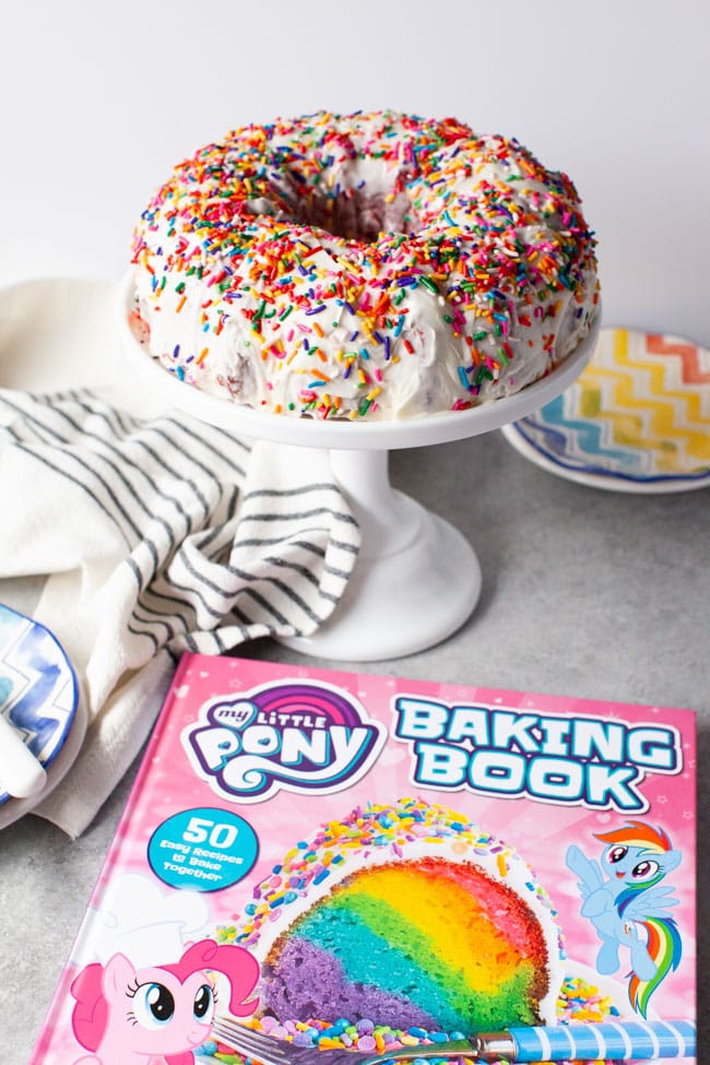 My Little Pony Baking Book next to tray of rainbow bundt cake