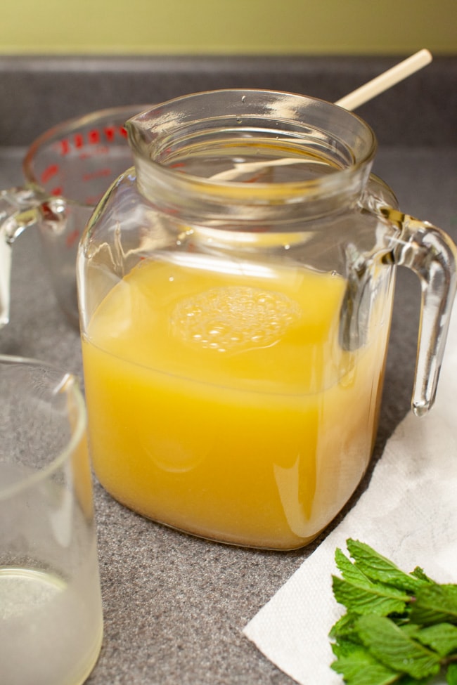orange mint tea in a jug on a kitchen counter
