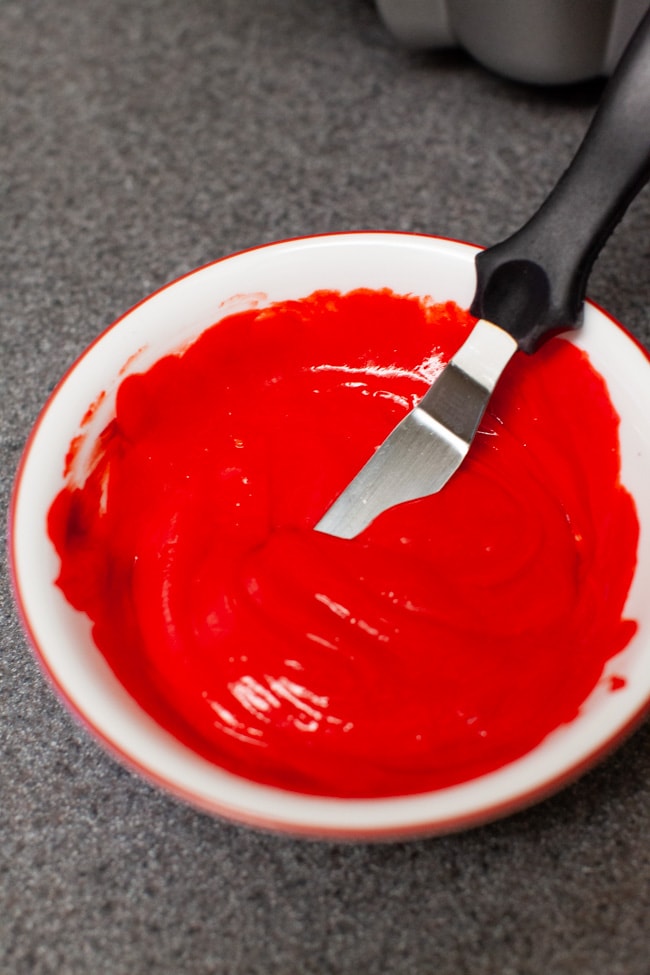 Bowl of cake batter with red food coloring 