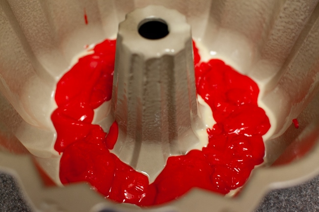 Red cake batter in Bundt cake pan