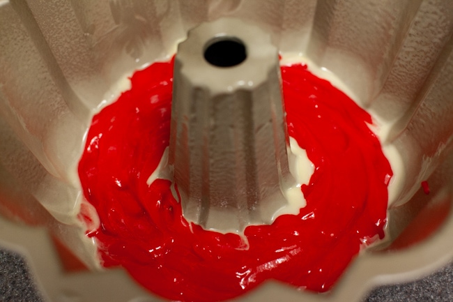 Red cake batter in Bundt cake pan