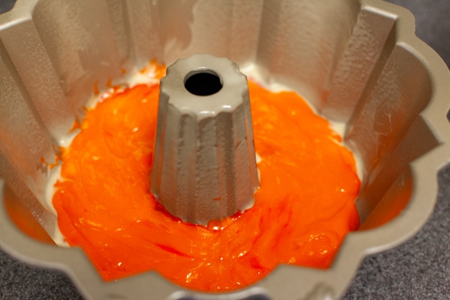 Orange cake batter in Bundt cake pan