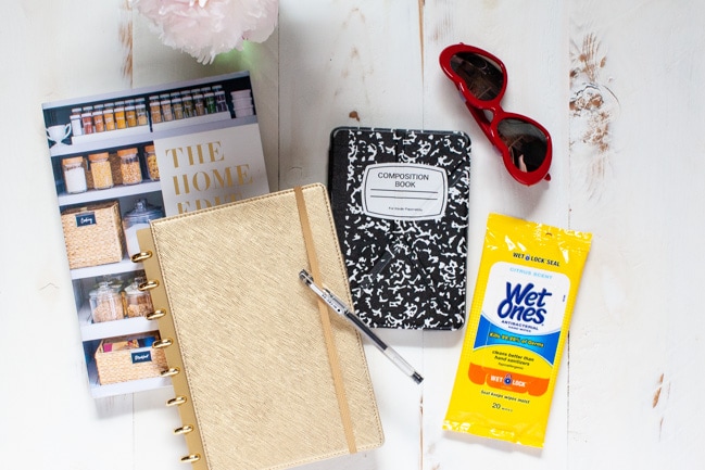 The Home Edit book, planner, pen, kindle, sunglasses and hand wipes