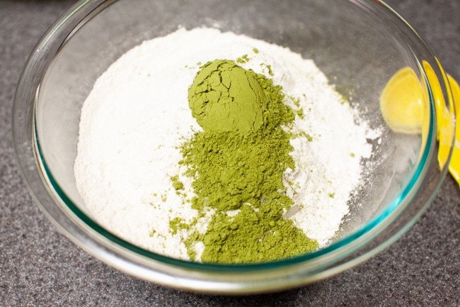 Matcha powder added to flour and salt in glass bowl for Matcha Cookies from thelittlekitchen.net