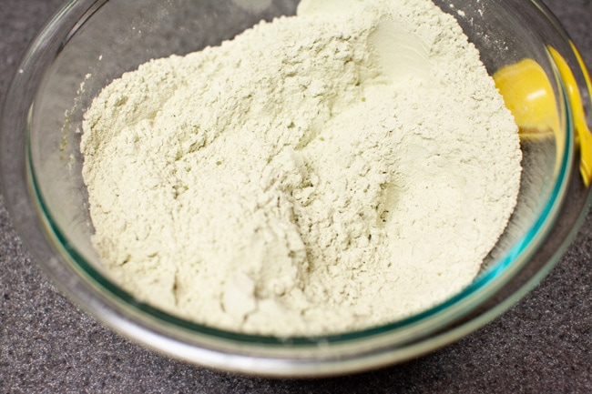 Matcha powder, flour, and salt mixed together in glass bowl for Matcha Cookies from thelittlekitchen.net