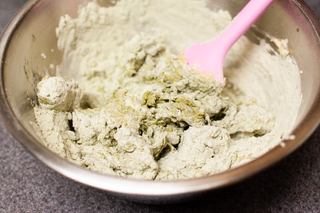 Using pink rubber spatula to mix Matcha Cookie batter in metal bowl from thelittlekitchen.net