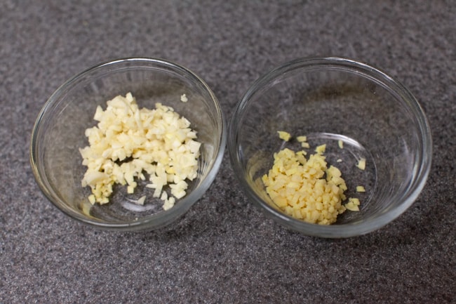 Two glass bowls with minced ginger and garlic