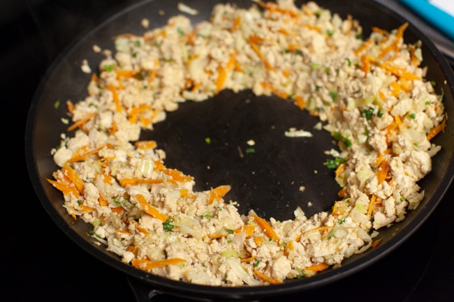 Vegetarian Dumpling filling pushed to the sides of a skillet from thelittlekitchen.net