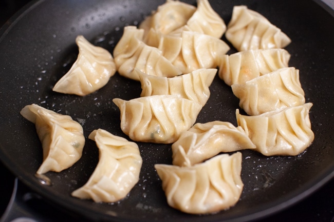 Cooked Vegetarian Dumplings in skillet from thelittlekitchen.net