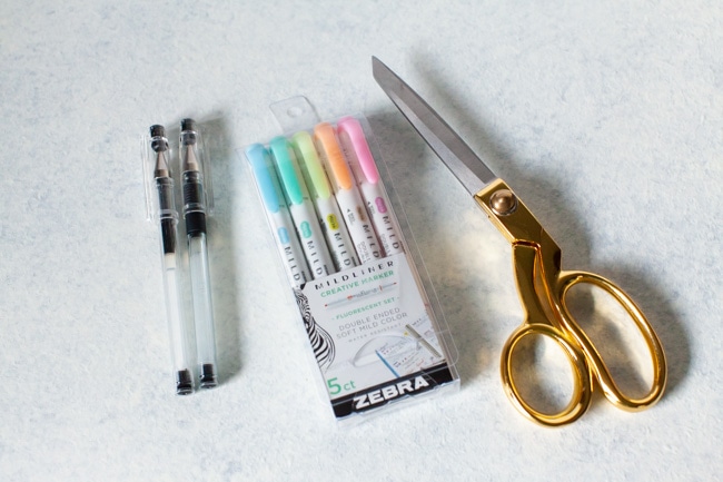 pens, highlighters and gold scissors
