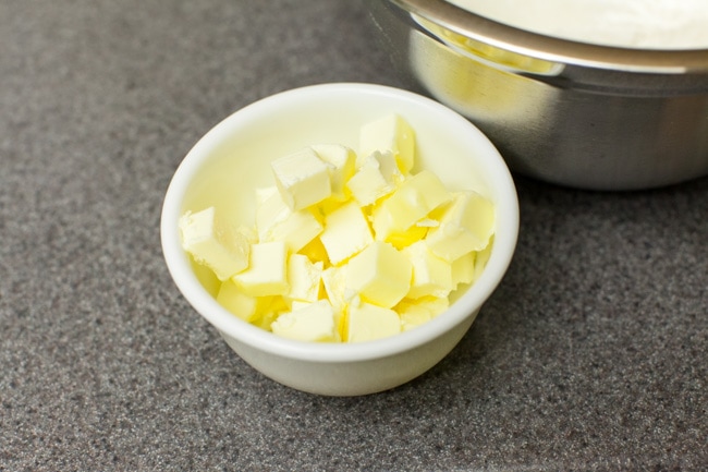 Cubed pieces of butter in small white bowl