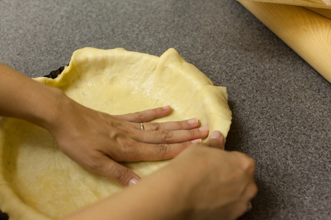 Hands pressing Sugar Pie dough into tart pan