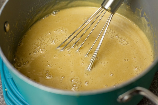 Whisking Sugar Pie filling in turquoise saucepan