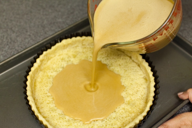 Pouring Sugar Pie filling into baked pie crust