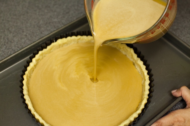 Pouring Sugar Pie filling into baked pie crust