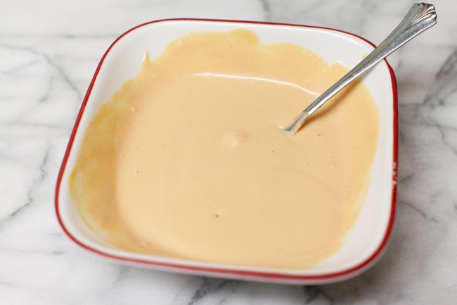 dipping sauce for cheeseburger egg rolls in a white bowl