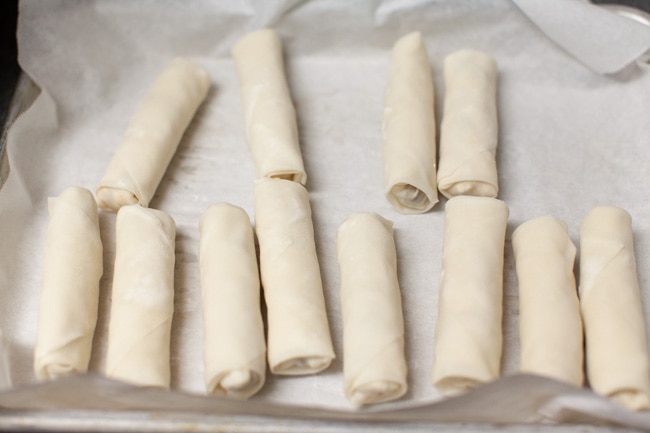 frozen egg rolls on a baking sheet