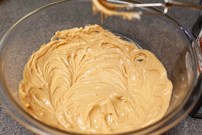 Peanut Butter and Shortening fully combined together in a glass bowl. 