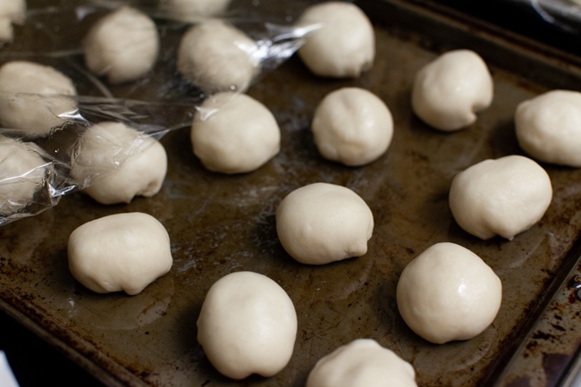 stuffed bagel bites before baking on a baking sheet