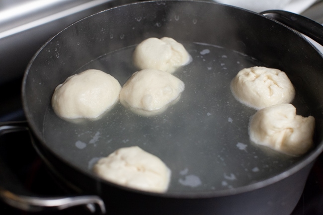 stuffed bagel bites in a pot of boiling water