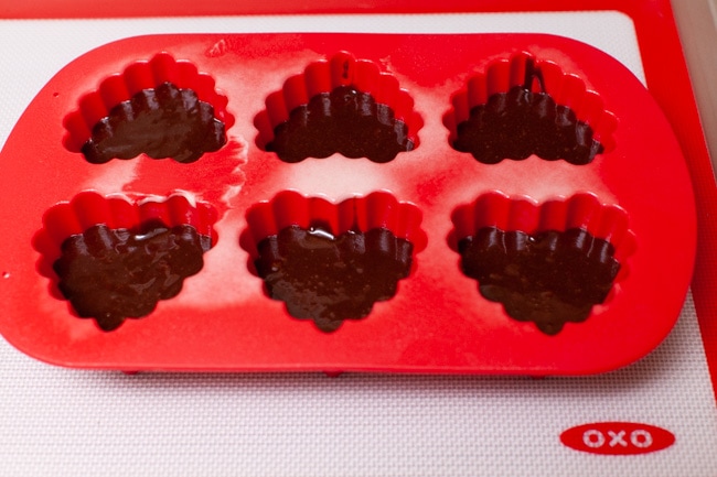 chocolate cake batter in a heart shaped silicone baking pan
