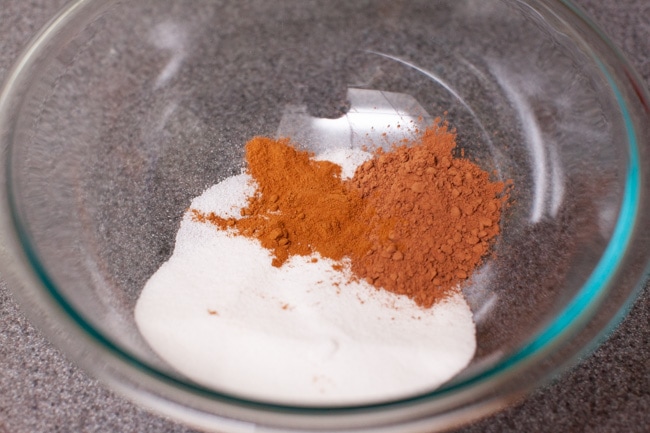 mixing sugar, cocoa powder and ground cinnamon in a glass mixing bowl