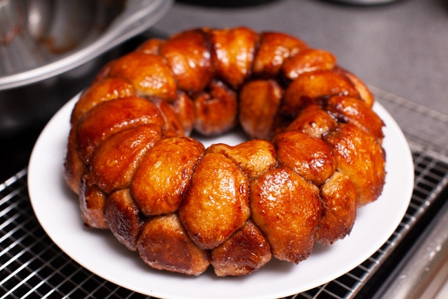 monkey bread on a plate with a napkin and a pitcher