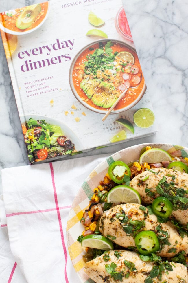 cilantro lime chicken on a plate with a Everyday Dinners cookbook in the background