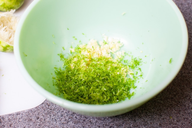 lime zest and garlic in a green mixing bowl