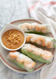 Vietnamese Spring Rolls with peanut dipping sauce on a plate with a napkin in the background
