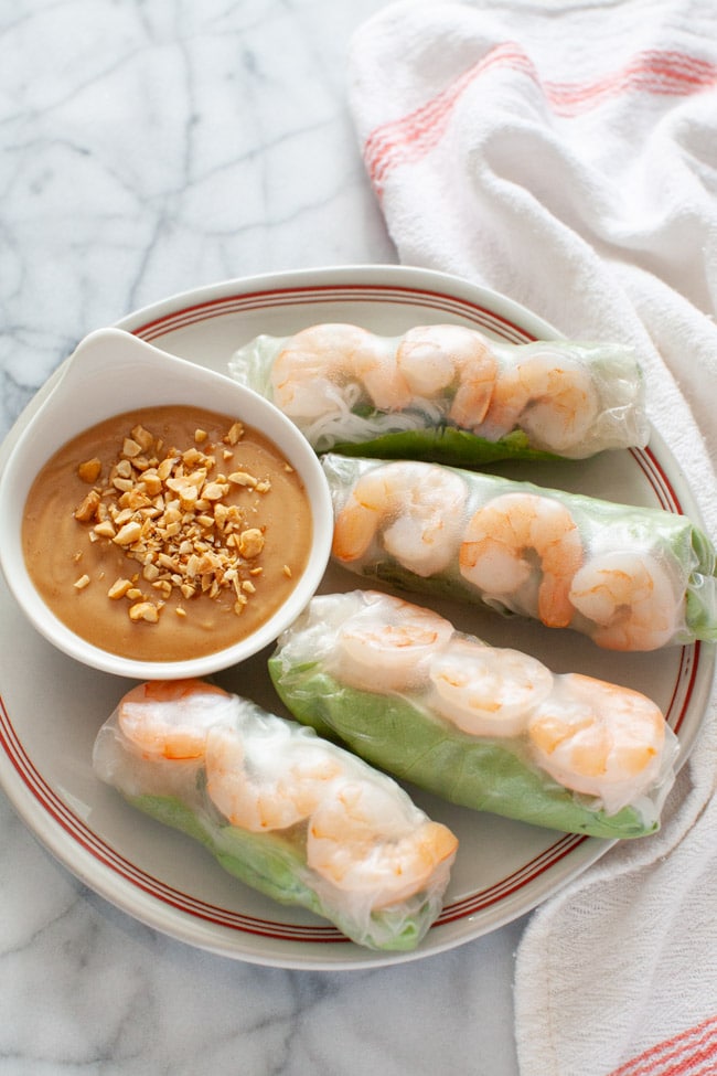 Vietnamese Spring Rolls with peanut dipping sauce on a plate with a napkin in the background