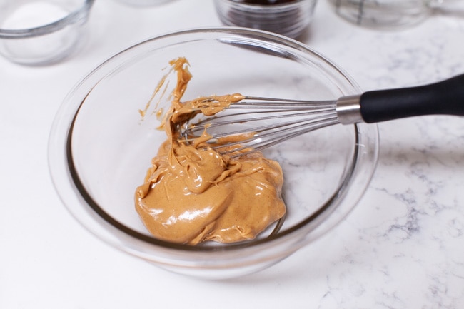 peanut butter in a bowl with a whisk