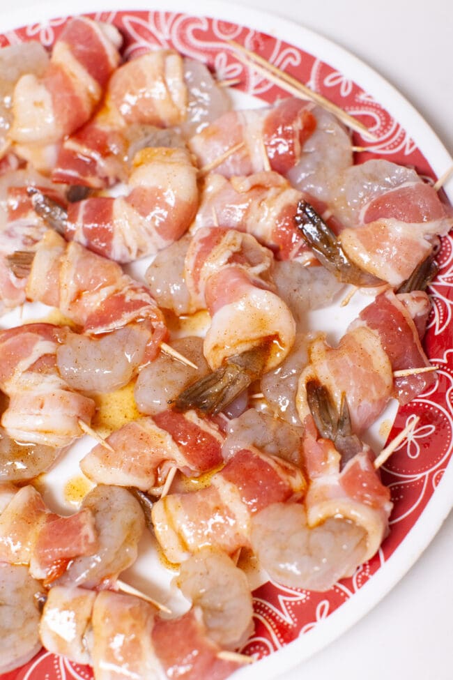 bacon wrapped shrimp in a bowl before putting them in the air fryer