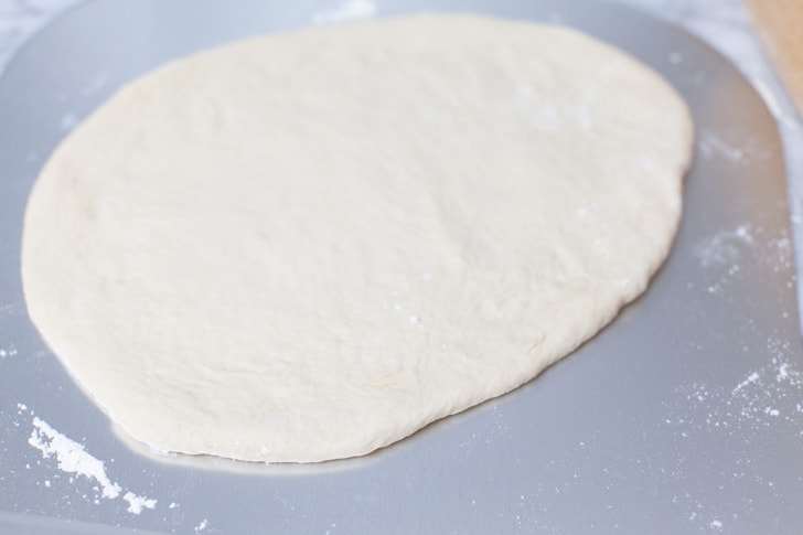 Pizza dough on a pizza peel