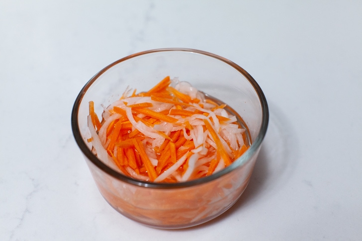 pickled carrots and daikon radish in a glass bowl