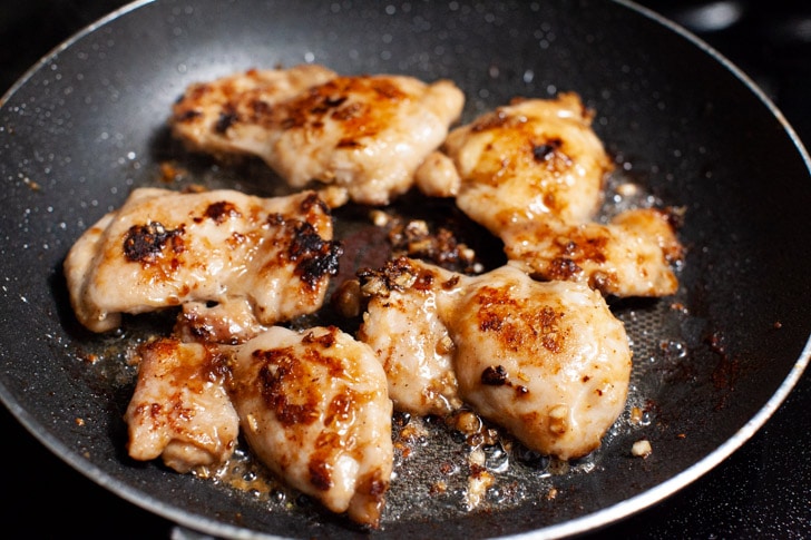 lemongrass chicken cooking in a nonstick skillet