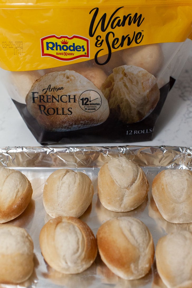 rhodes warm & serve rolls on a baking sheet with a bag of rolls in the background